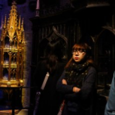 Woman looking around in Dumbledore's office. © Violet Acevedo
